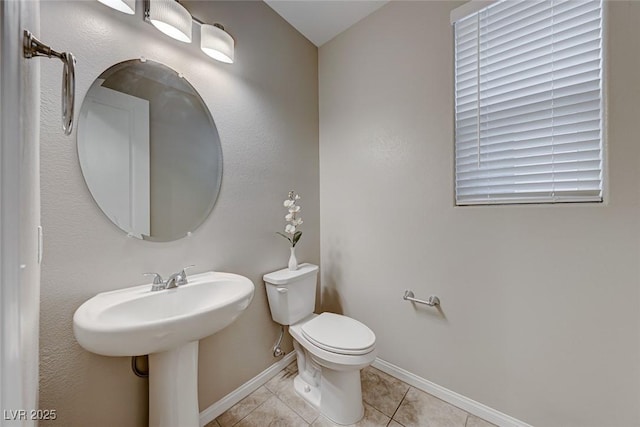 bathroom featuring sink, toilet, and tile patterned flooring