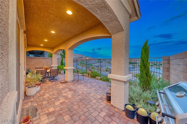 patio terrace at dusk with a grill