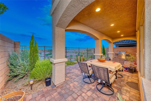 view of patio terrace at dusk