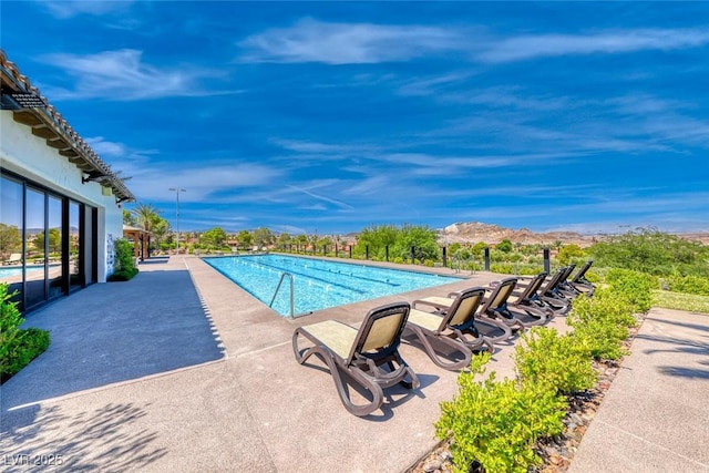 view of swimming pool with a patio