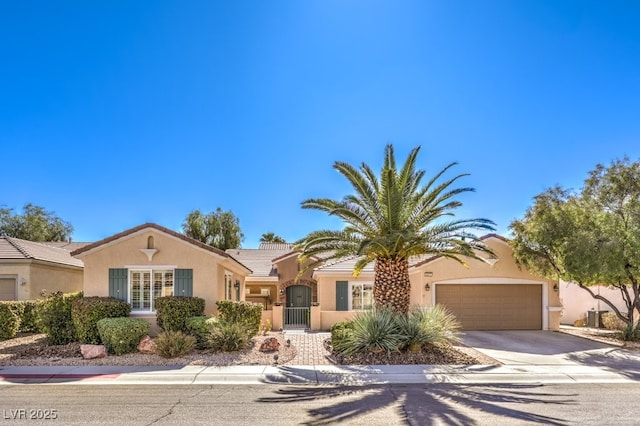 view of front of house featuring driveway, a garage, central AC unit, a tile roof, and stucco siding