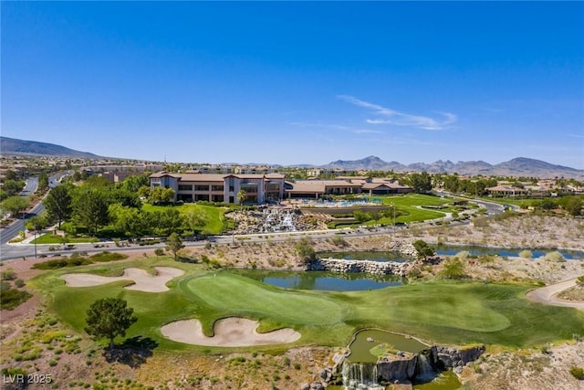 view of property's community with golf course view and a water and mountain view