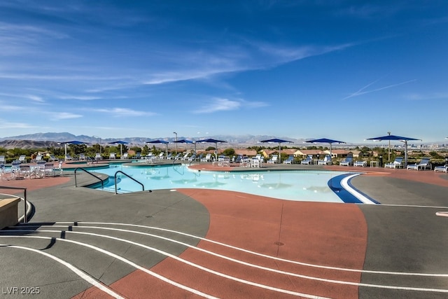 pool featuring a mountain view and a patio