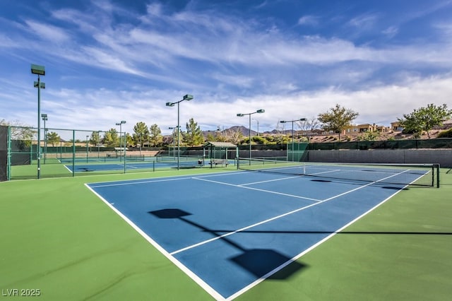 view of sport court featuring fence