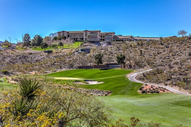 view of home's community with a yard and golf course view