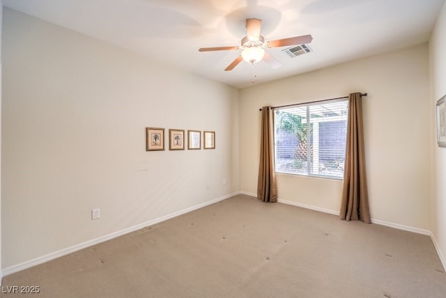 unfurnished room with ceiling fan, visible vents, baseboards, and light colored carpet