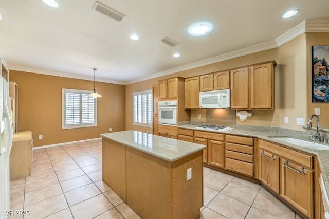 kitchen with white appliances, visible vents, pendant lighting, and a sink