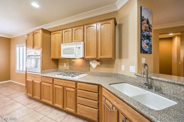 kitchen with crown molding, white appliances, and a sink