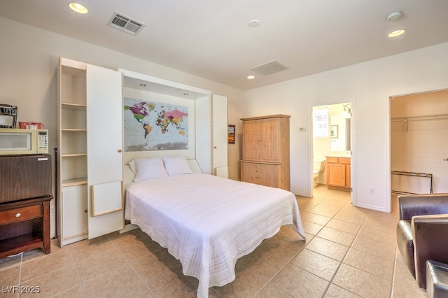 bedroom featuring light tile patterned floors, a spacious closet, visible vents, and recessed lighting