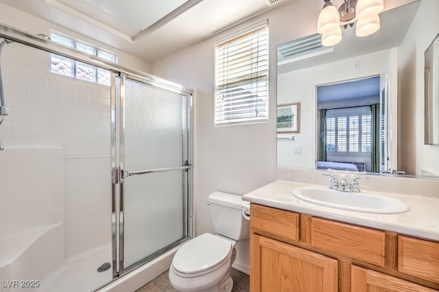 ensuite bathroom with a tile shower, vanity, toilet, and ensuite bathroom