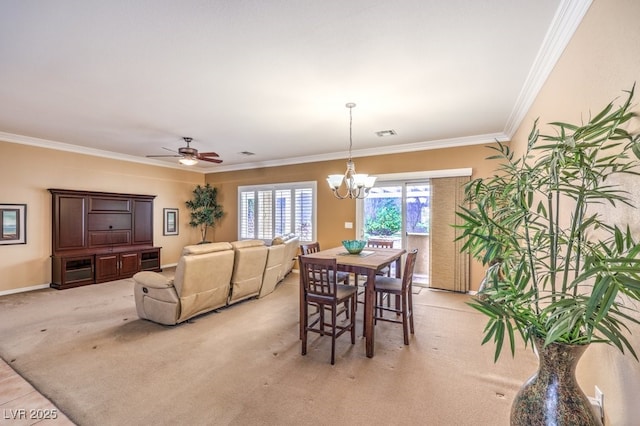 dining space with crown molding, light colored carpet, visible vents, baseboards, and ceiling fan with notable chandelier