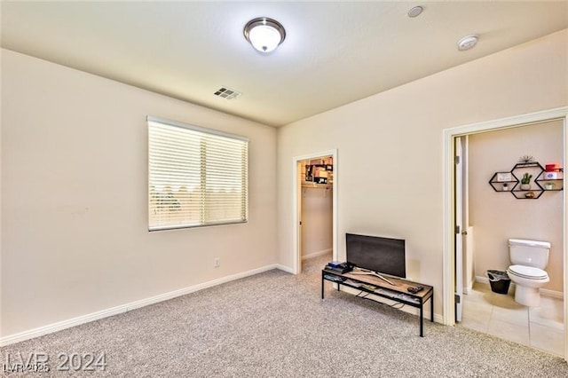 sitting room featuring light colored carpet