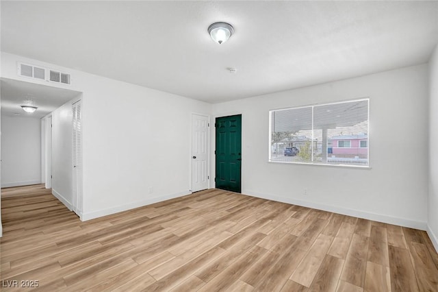 unfurnished room with light hardwood / wood-style flooring