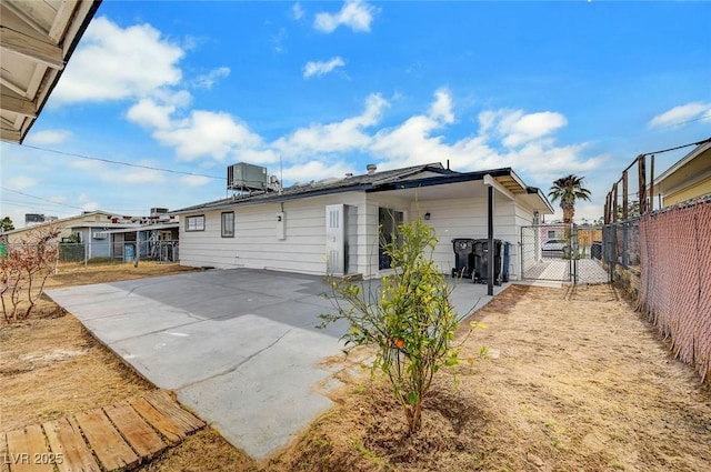 back of house featuring a patio and central air condition unit