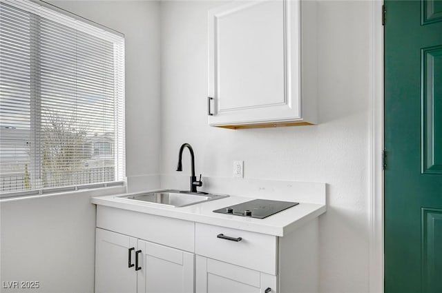 kitchen featuring sink and white cabinets