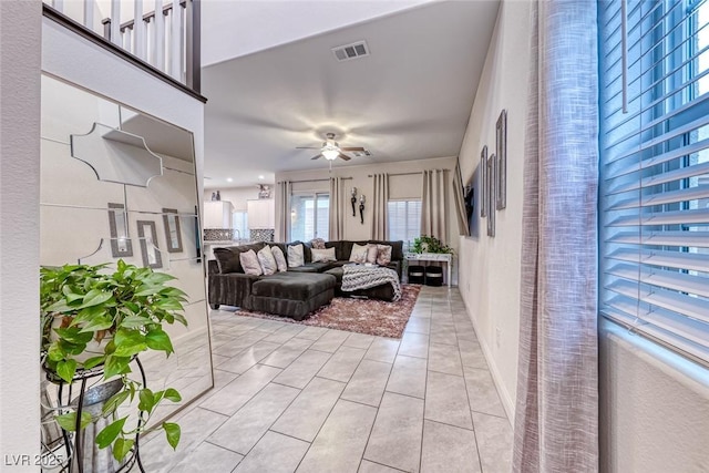 living room with light tile patterned floors and ceiling fan