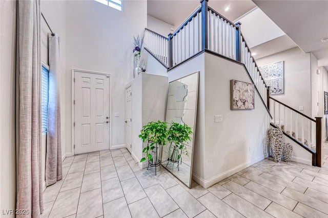 entryway featuring a towering ceiling