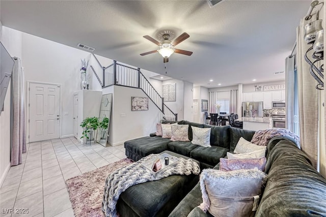 tiled living room with ceiling fan