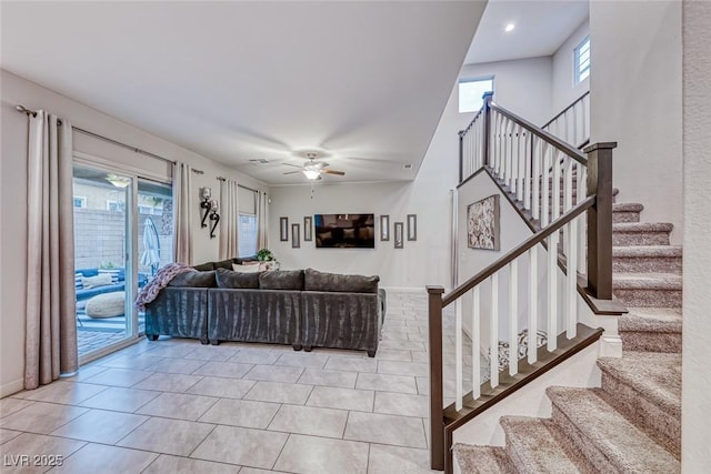 tiled living room with a wealth of natural light and ceiling fan