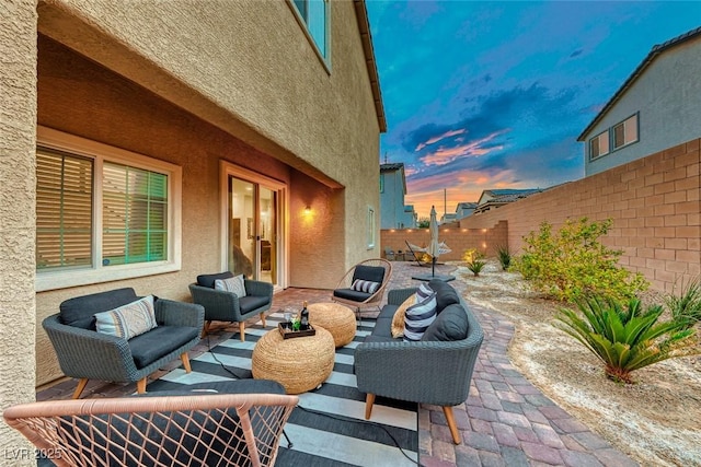 patio terrace at dusk featuring outdoor lounge area