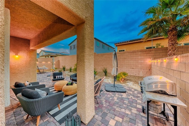 patio terrace at dusk with a grill