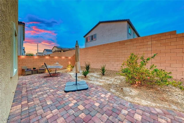 view of patio terrace at dusk