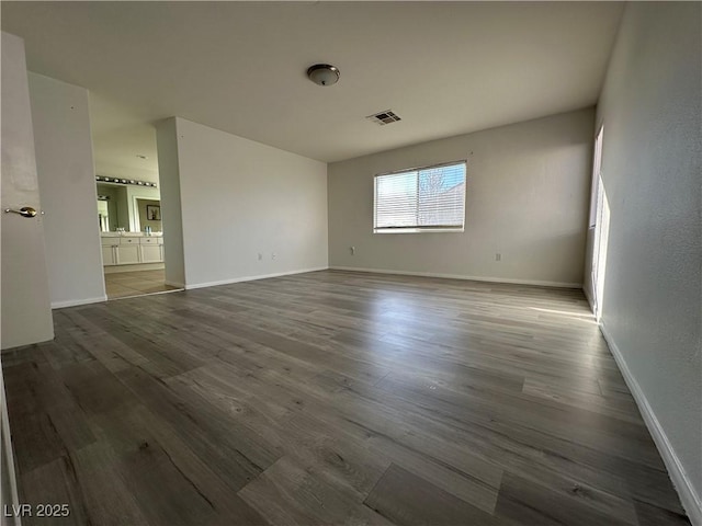 empty room with hardwood / wood-style flooring