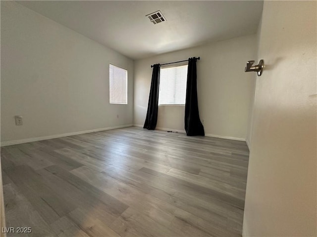 spare room with wood-type flooring