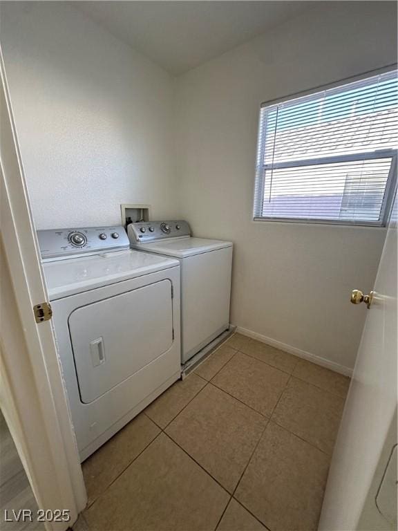 laundry room featuring washer and dryer and light tile patterned flooring