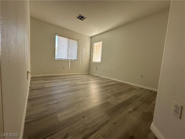 unfurnished room with wood-type flooring