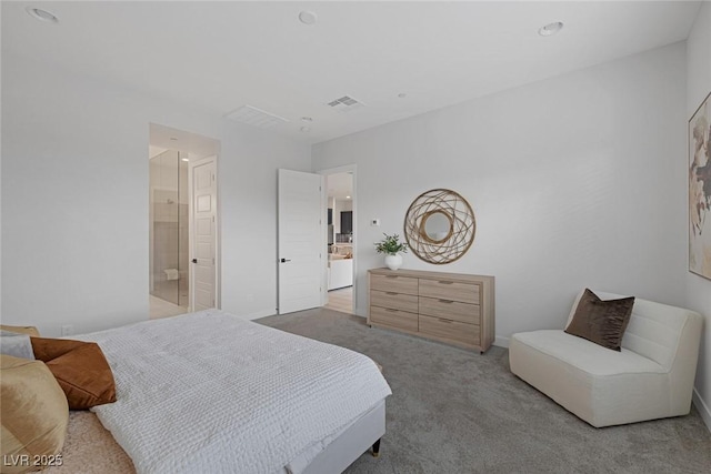 carpeted bedroom with ensuite bath