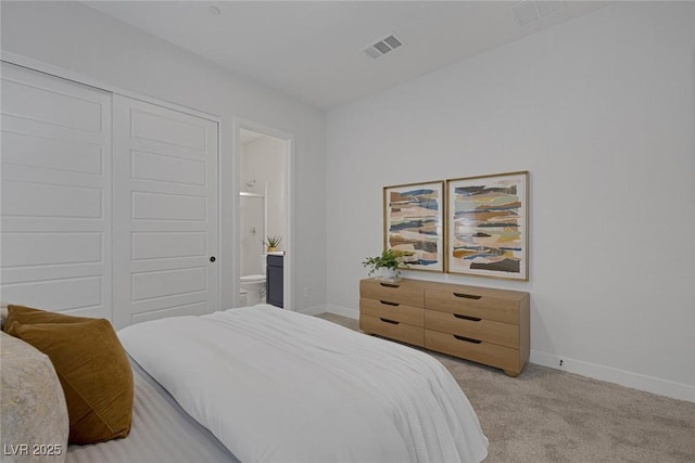 bedroom featuring light carpet, connected bathroom, and a closet