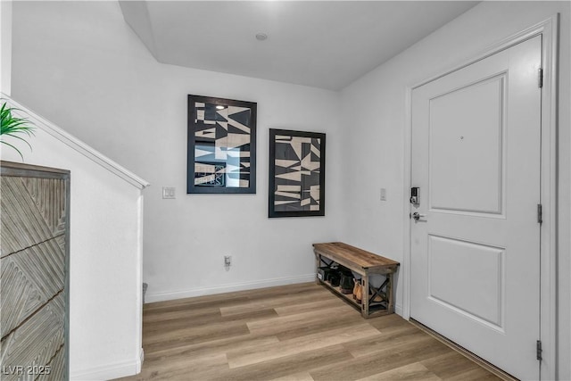 entryway with baseboards and wood finished floors