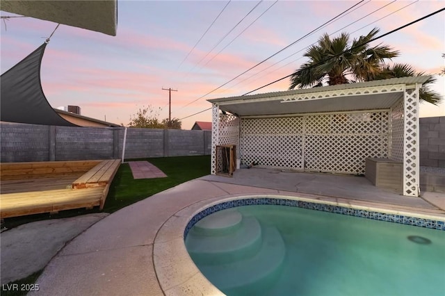 view of pool at dusk