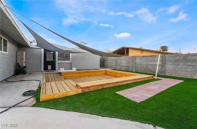 view of yard with a wooden deck, central AC, and a patio