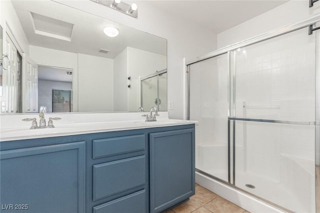 bathroom with tile patterned flooring, vanity, and a shower with shower door