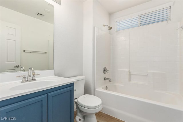 full bathroom with vanity, tub / shower combination, hardwood / wood-style floors, and toilet