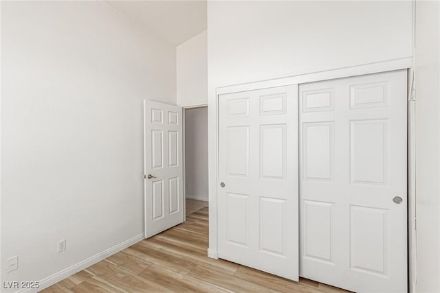 unfurnished bedroom featuring a closet and light hardwood / wood-style flooring