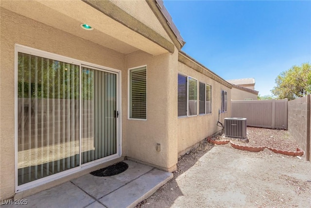 doorway to property with a patio area and central air condition unit