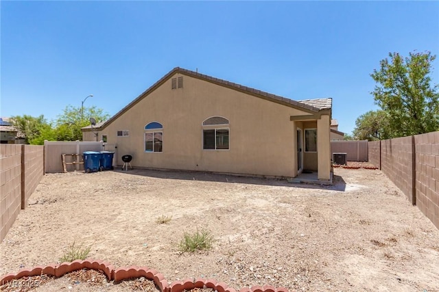 rear view of property featuring central AC unit