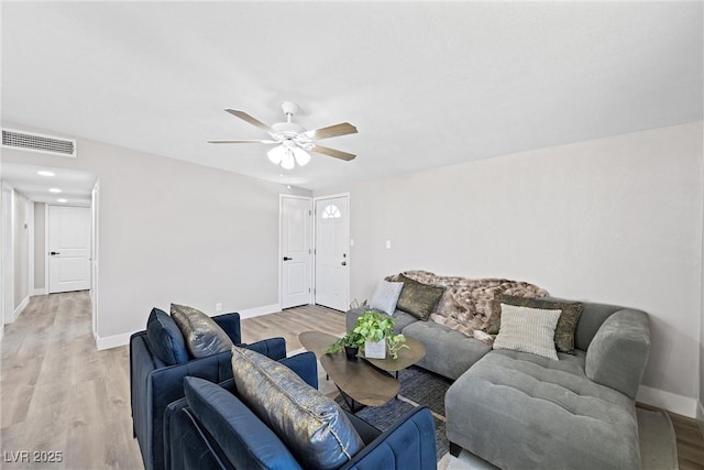 living room featuring light hardwood / wood-style flooring and ceiling fan