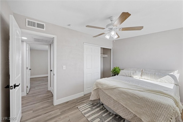 bedroom featuring ceiling fan, a closet, and light wood-type flooring