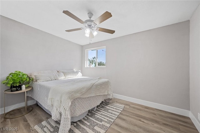 bedroom with hardwood / wood-style floors and ceiling fan