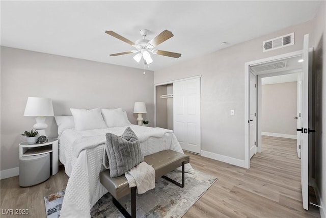 bedroom with light hardwood / wood-style flooring, ceiling fan, and a closet