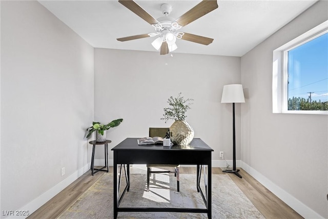 office space with ceiling fan and light hardwood / wood-style floors