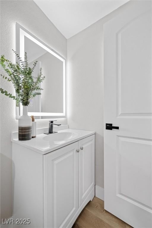 bathroom with vanity and hardwood / wood-style floors