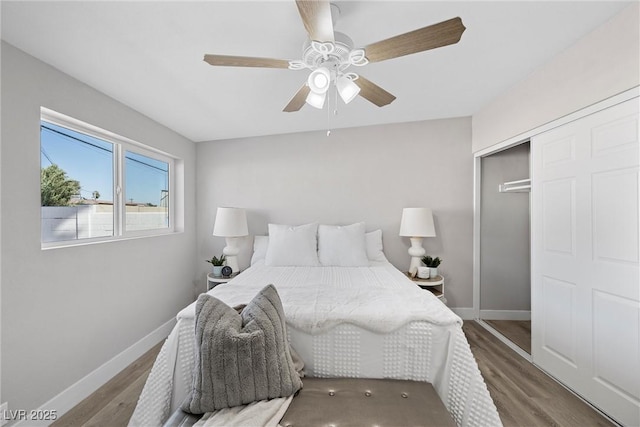 bedroom with wood-type flooring, ceiling fan, and a closet