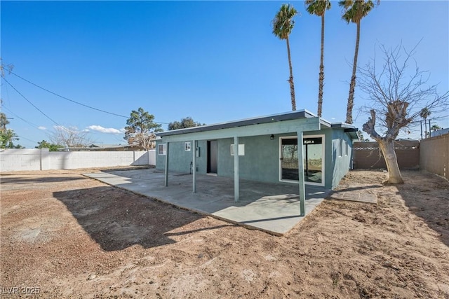 back of property featuring a patio