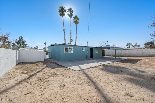 back of property with a carport