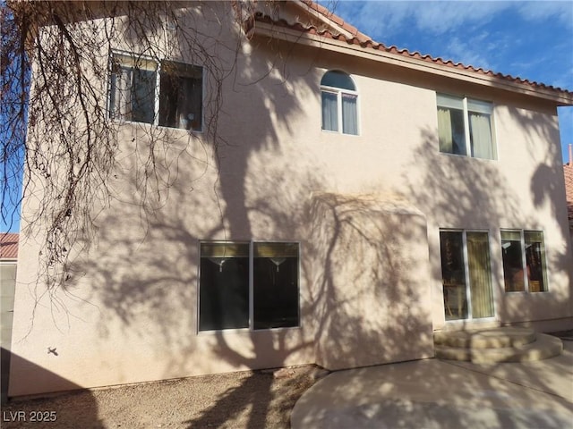 view of property exterior with a patio area